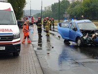 Ratownicy medyczni i strażacy przy uszkodzonym samochodzie chevrolet
